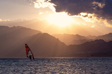 Wind-surfer on the water in Lagoon Dahab area at sunset, Sinai, EgyptWind-surfer on the water in...