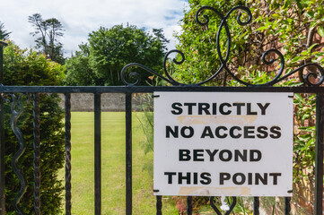 Sign in a garden "strictly no access beyond this point"