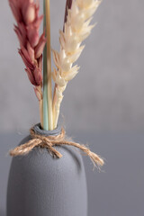 Colored wheat. Gray vase. Interior decor. Ukrainian flavor. Jute rope. Painted dried flowers. A bouquet of ears of corn. A symbol of life. Interior decor. Symbol of Ukraine.