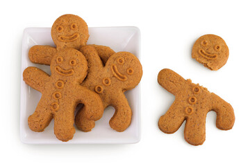 Gingerbread man in ceramic bowl isolated on white background. Top view. Flat lay.