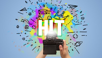 Close-up of a hand holding digital camera with abstract drawing
