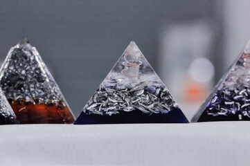 Orgone Devices on sale at a holistic and spiritual fair.  These are claimed to reduce electromagnetic energy from electrical appliances but contain just scrap metal and plastic resin. - obrazy, fototapety, plakaty