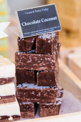 Chocolate coconut cream and butter fudge on sale at a market stall