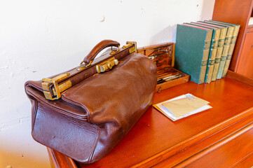 Old-fashioned doctor's surgeon's bag on a desk 