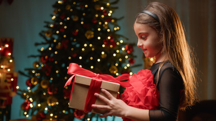 Fototapeta na wymiar Young girl receiving present from Santa Claus 