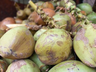 Close up photo of Coconut. Young coconut is a fresh drink that quenches thirst and warms the mind made from the flesh and water of young coconuts. Photo concept as background or wallpaper.
