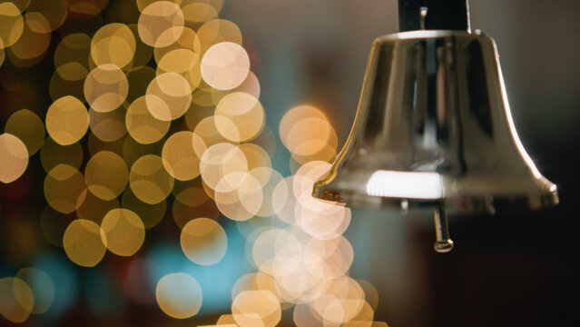 Shaking and ringing bell with blurred Christmas background