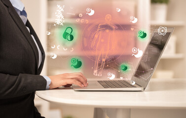 Doctor working on laptop with healthcare concept