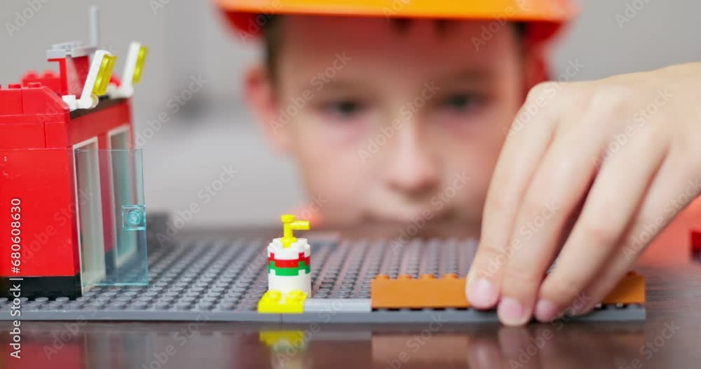 Aufkleber child hands play with colorful plastic toy bricks and constructor game blocks.