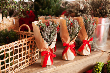 christmas bouquet decorations in craft paper at florist shop or xmas market