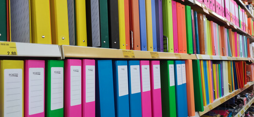 School goods and other stationery from various manufacturers on shelves of store.