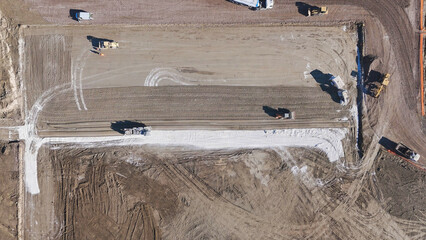 Earthmoving equipment. Aerial view of a large construction site with several earthmoving machines.