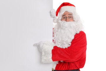 Man in Santa Claus costume posing and pointing on white background