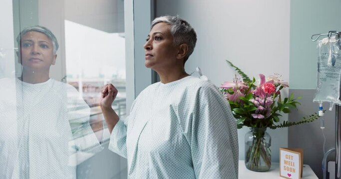 Sad, woman and thinking at window in hospital with stress, anxiety or fear of cancer, death or insurance. Senior, patient and depression in clinic with lady worried for future or mental health