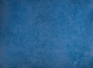 Blue velvet fabric used for sewing clothes for store. Textile material of velours texture as background. Catalog photo of samples. 