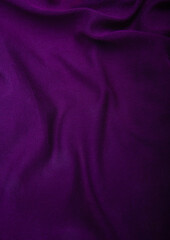 Crumpled dark violet fabric used for sewing clothes for store. Textile material polyester,knitted...