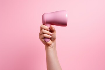 hand firmly holding a pink megaphone against a matching pink background