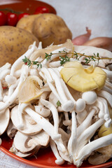 Ingredients for dinner dish with potato and mushrooms with onion. White shimeji edible mushrooms native to East Asia, buna-shimeji is widely cultivated