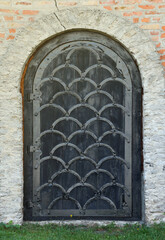 Very old solid door in brick stone wall of castle or fortress of 18th century. Full frame wall with door close up