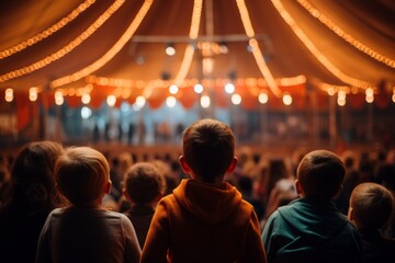 rear view kid children watching show on stage in circus carnival festive celebration in dome tent with crowd people inside exited lifestyle - obrazy, fototapety, plakaty