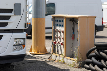 A White Truck Parked in a Parking Lot Surrounded by Other Trucks