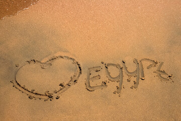 Beach. Shore of the Red Sea. Inscription on yellow sand. Egypt.