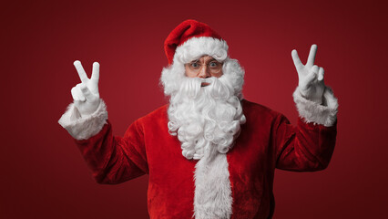 Fototapeta na wymiar Santa Claus with peace signs, spreading joy and love on Christmas
