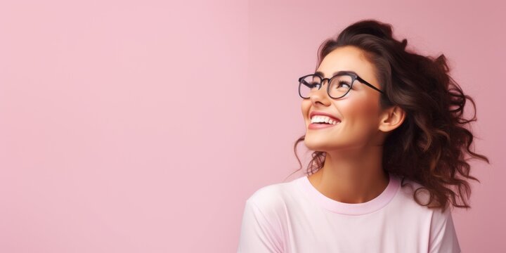 Woman in glasses looking over pastel pink background. Background concept