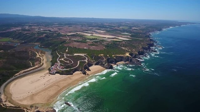 Aerial video filming by drone of the sea bay and beach near the village of Odeceixe Alentejo Portugal. View of the Alentejo region