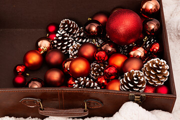 Maleta con bolas rojas para decoración navideña. - obrazy, fototapety, plakaty
