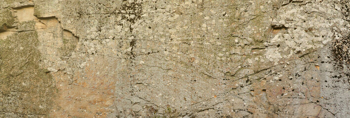 Closeup of the rough stone texture of a big rock surface for natural background concepts. Closeup dirty natural stone background texture in warm tones