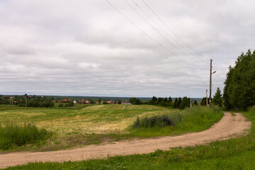 rural landscape, road to a village around a field