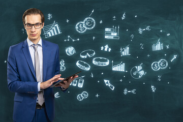 Businessman in blue suit presenting financial strategy on chalkboard. Education and analysis concept