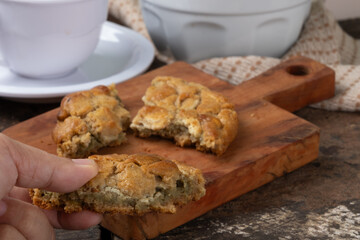 Woman tasting delicious cookie. Selective focus.