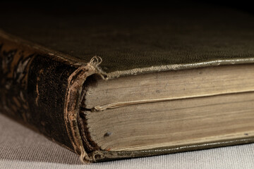 An ancient thick book with a leather cover. A shabby old book