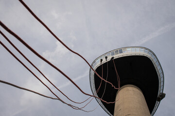 daring adrenaline junkies abseil from the Euromast tower in Rotterdam Netherlands to the ground. rappelling sport people in action over the edge