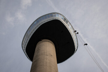 daring adrenaline junkies abseil from the Euromast tower in Rotterdam Netherlands to the ground....