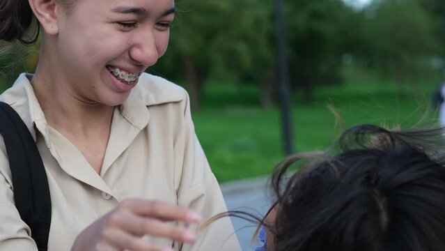 Two teenage sisters smile, have fun and communicate with each other. Friendship, family and healthcare concept