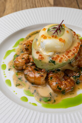 poached egg with avocado, tiger prawns and red caviar