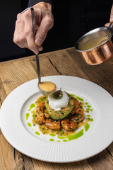 poached egg with avocado, tiger prawns and red caviar