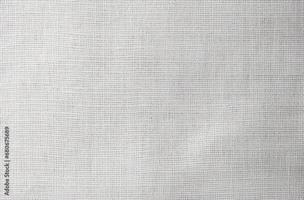 Poster a close up of a white cloth textured with a small amount of stitching on the outside of the fabric.
