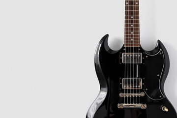Fototapeta na wymiar Old black gelectric guitar on white background. Musical wallpaper
