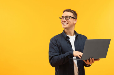 Happy young man student using new modern laptop