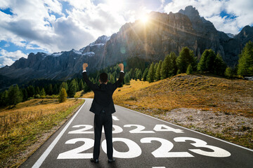 2024 New Year journey and future vision concept . Businessman traveling on highway road leading...