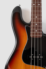 close-up photo of a black bass guitar on a white background