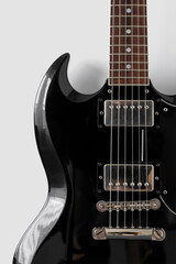 Fototapeta na wymiar close-up photo of a black guitar on a white background