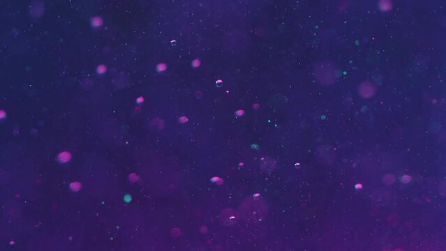 Abstract background. Bubbles liquid. Underwater effect. Purple fluid with air floating up defocused bokeh light shiny shimmering particles smooth motion.