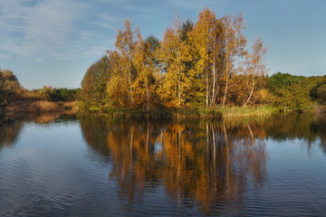 Fototapeta na wymiar Autumn pond, reflection of trees in the water in autumn colors. Gdansk, Poland