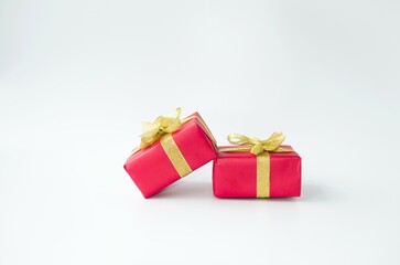Banner, on a white background, beautiful red holiday boxes with a gold bow.  Space for copying text.  Holiday concept New Year and Christmas, Valentine's Day.  Seasonal promotions and sales.