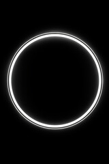 White ring of light on black background with black background.